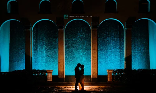 Couple Silhouette Under Teal-Lit Arches at The Bell Tower on 34th