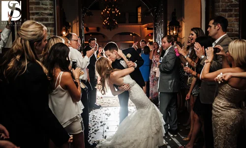 Guests Line the Aisle as Newlyweds Exit at The Bell Tower on 34th