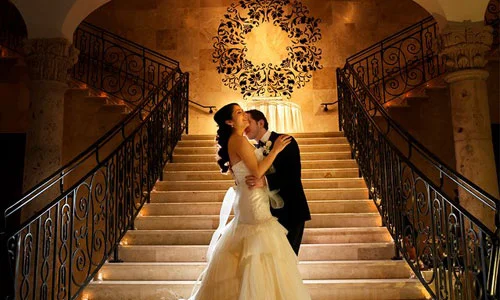 Newlyweds Embrace on the Grand Staircase at The Bell Tower on 34th
