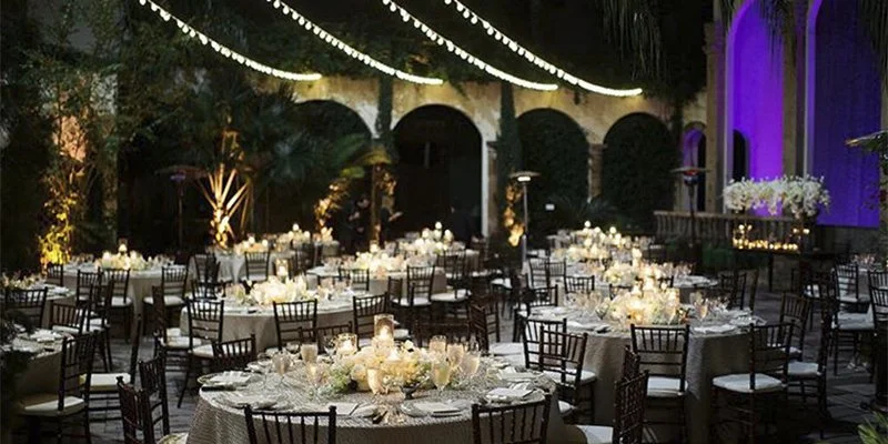 Beautiful indoor chapel-style ceremony space with candlelight, classical architecture, and a grand chandelier at the Houston wedding venue.